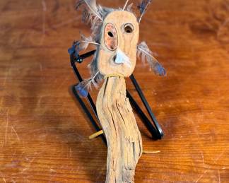 "Bad Spirit of the Mountain", an original carving by listed Alaskan artist, Adam John. Signed and titled on the verso circa 2002 and measures, 12” H x 5” W. Adam John is a noted Athabascan Native artist from Alaska, known for his traditional carvings, especially spirit masks and small sculptures, often depicting animals like owls or mountain spirits, and signed pieces can be found on art sites and auction platforms like eBay, continuing a heritage of Alaskan Native art. He’s associated with Central Alaska and his work is recognized for its cultural significance and craftsmanship. 

