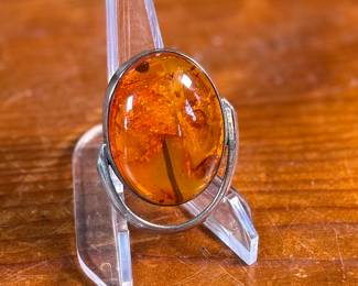 This lot features a stunning Baltic Amber in a sterling silver setting to be used as a brooch or pendant. This piece has a total approx. weight of 15.06 grams.

