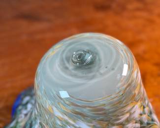 This lot features a stunning art glass vase by listed artist, Mark Russell. Signed underneath as shown in photos and measures, 7” H x 11” W x 11” D.

