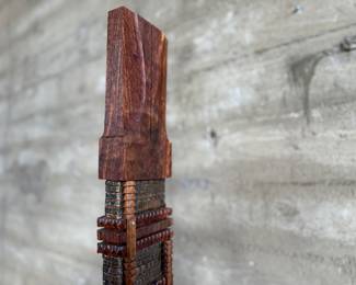 This lot features an incredible mahogany and copper sculpture by listed Oregon artist, Monica Setziol-Phillips. This piece sits in a custom iron base and measures, 75” H x 18” W x 13” D. Monica Setziol-Phillips has a B.A. degree in foreign languages from Portland State University. Monica who is married to Oregon Shakespeare Festival actor, Josiah Phillips, and daughter of well rememberd sculptor, Le Roy Setziol has been weaving for over 35 years and carving for over 20 years. Her work is in many private collections in many states. She also has work in puplic spaces, most recently three of her pieces were chosen for The Allison, the new resort in Newberg. In October of 2009 Monica finished a major work for the new Civic Hall in McMinnville, Oregon. For a number of years she has participated in the Sitka Art Invitational.

