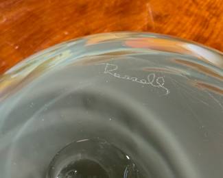 This lot features a stunning art glass vase by listed artist, Mark Russell. Signed underneath as shown in photos and measures, 7” H x 11” W x 11” D.

