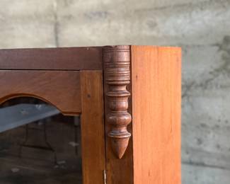 This lot features an early antique cherry wood display cabinet or bookcase. Two pieces (base is separate) with locking doors and skeleton key included. One glass pane is missing and some trim could be reattached that is included. This piece measures, 56.25” H x 42” W x 16.5” D.

