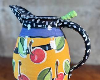 This lot features a studio made pitcher by listed Oregon artist, Mary Lou Zeek. Signed underneath and measures, 13” H x 9” W x 7” D.

