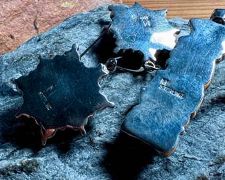 This lot features a stunning pair of Navajo earrings and a pendant made with sterling silver, turquoise, and spiny oyster shell jewelry. All items marked 925 with a total approx. weight of 26.82 grams. Signed by artist, "M".

