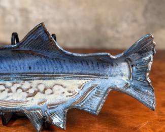 This lot features a fish tray by Blue Spruce Pottery. Signed on the verso and measures, 2” H x 15.5” W x 7” D. Minor repair done to a fin as shown.

