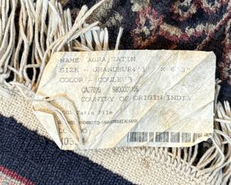 This lot features a handcrafted 100% satin pile Agra rug, made in India that measures, 75” H x 49” W.

