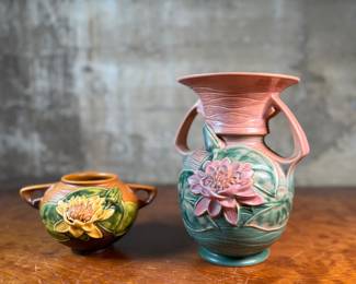 This lot features a pair of antique Roseville Pottery Vases. Two minor chips shown in photos and larger vase measures, 9.25” H x 8” W x 7” D.

