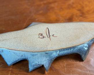 This lot features a fish tray by Blue Spruce Pottery. Signed on the verso and measures, 2” H x 15.5” W x 7” D. Minor repair done to a fin as shown.

