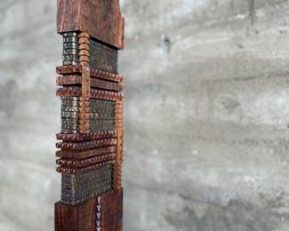 This lot features an incredible mahogany and copper sculpture by listed Oregon artist, Monica Setziol-Phillips. This piece sits in a custom iron base and measures, 75” H x 18” W x 13” D. Monica Setziol-Phillips has a B.A. degree in foreign languages from Portland State University. Monica who is married to Oregon Shakespeare Festival actor, Josiah Phillips, and daughter of well rememberd sculptor, Le Roy Setziol has been weaving for over 35 years and carving for over 20 years. Her work is in many private collections in many states. She also has work in puplic spaces, most recently three of her pieces were chosen for The Allison, the new resort in Newberg. In October of 2009 Monica finished a major work for the new Civic Hall in McMinnville, Oregon. For a number of years she has participated in the Sitka Art Invitational.

