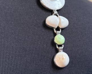 This lot features a special custom necklace by listed designer, Melanie DeLuca. Engraved sterling silver with shells & stones throughout. This piece measures, 17” and has a total approx. weight of 193.49 grams. Melanie DeLuca’s bold jewelry designs of mixed media, plastics and ethnographic objects embody a celebration of her 45 years as a metalsmith, jewelry designer and master teacher. Her interest in jewelry design began early and solidified at 17. By 20, she was apprenticing for master silversmith Brooks Darrow (himself an apprentice of renowned English architect and master metalsmith Louis Osman). Early work in painting and sculpture informed Melanie’s growing connection to the limitless expression of metal through jewelry design and fabrication.


