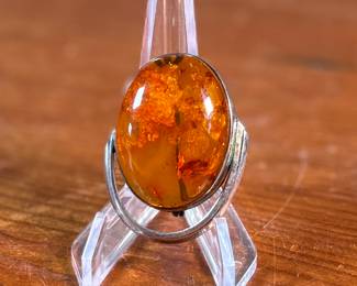 This lot features a stunning Baltic Amber in a sterling silver setting to be used as a brooch or pendant. This piece has a total approx. weight of 15.06 grams.

