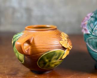 This lot features a pair of antique Roseville Pottery Vases. Two minor chips shown in photos and larger vase measures, 9.25” H x 8” W x 7” D.

