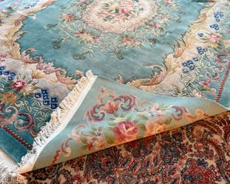 This lot features a hand-knotted Chinese Aubusson wool rug featuring a floral medallion design that measures, 144” H x 107” W.

