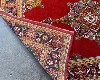 This lot features an antique handwoven Persian rug that measures, 74” H x 49” W.

