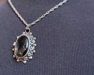 This lot features a "poison locket" pendant on a sterling silver chain measuring 18” with a total approx. weight of 34.31 grams.

