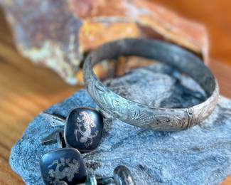 This lot features a curated collection of antique sterling silver items including a bracelet, Taxco earrings, Siam cufflinks, & a belt buckle. Total approx. weight of 63.44 grams.

