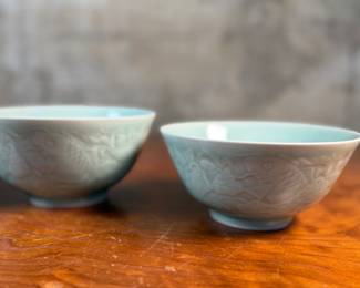 This lot features a set of three (3) celadon bowls. The two on each side are matching and the one in the middle a tad larger, measuring 3.25” H x 6.5” W x 6.5” D. The bowl on the right has a tiny chip on rim that is photographed, but not noticeable.

