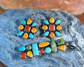 This lot features a stunning pair of Navajo earrings and a pendant made with sterling silver, turquoise, and spiny oyster shell jewelry. All items marked 925 with a total approx. weight of 26.82 grams. Signed by artist, "M".

