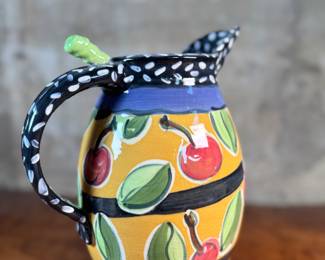 This lot features a studio made pitcher by listed Oregon artist, Mary Lou Zeek. Signed underneath and measures, 13” H x 9” W x 7” D.

