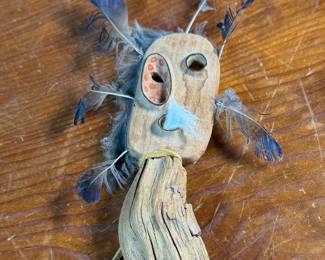 "Bad Spirit of the Mountain", an original carving by listed Alaskan artist, Adam John. Signed and titled on the verso circa 2002 and measures, 12” H x 5” W. Adam John is a noted Athabascan Native artist from Alaska, known for his traditional carvings, especially spirit masks and small sculptures, often depicting animals like owls or mountain spirits, and signed pieces can be found on art sites and auction platforms like eBay, continuing a heritage of Alaskan Native art. He’s associated with Central Alaska and his work is recognized for its cultural significance and craftsmanship. 

