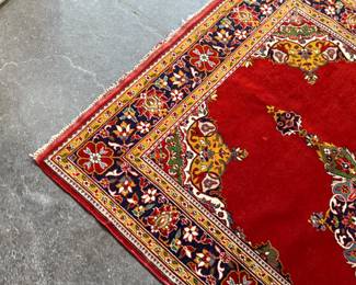 This lot features an antique handwoven Persian rug that measures, 74” H x 49” W.

