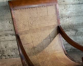 This lot features a British Colonial style plantation lounge chair with a matching ottoman in very good overall condition. The chair measures, 41” H x 24.5” W x 33” W.

