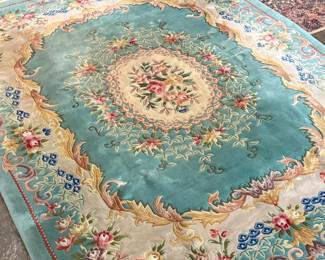 This lot features a hand-knotted Chinese Aubusson wool rug featuring a floral medallion design that measures, 144” H x 107” W.

