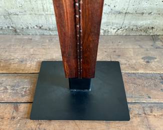 This lot features an incredible mahogany and copper sculpture by listed Oregon artist, Monica Setziol-Phillips. This piece sits in a custom iron base and measures, 75” H x 18” W x 13” D. Monica Setziol-Phillips has a B.A. degree in foreign languages from Portland State University. Monica who is married to Oregon Shakespeare Festival actor, Josiah Phillips, and daughter of well rememberd sculptor, Le Roy Setziol has been weaving for over 35 years and carving for over 20 years. Her work is in many private collections in many states. She also has work in puplic spaces, most recently three of her pieces were chosen for The Allison, the new resort in Newberg. In October of 2009 Monica finished a major work for the new Civic Hall in McMinnville, Oregon. For a number of years she has participated in the Sitka Art Invitational.

