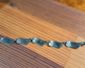 This lot features a gorgeous set of Taxco jewelry with sterling silver and inlaid blue stone with a marble-like appearance. The necklace measures, 17” and the bracelet, 7”. All items bear a maker’s mark as shown in photos with a total approx. weight of 58.00 grams.

