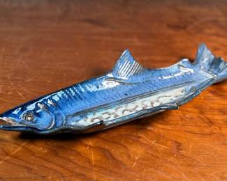 This lot features a fish tray by Blue Spruce Pottery. Signed on the verso and measures, 2” H x 15.5” W x 7” D. Minor repair done to a fin as shown.

