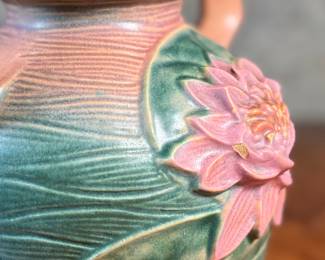 This lot features a pair of antique Roseville Pottery Vases. Two minor chips shown in photos and larger vase measures, 9.25” H x 8” W x 7” D.

