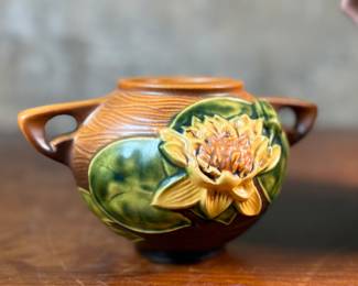 This lot features a pair of antique Roseville Pottery Vases. Two minor chips shown in photos and larger vase measures, 9.25” H x 8” W x 7” D.

