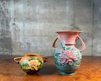 This lot features a pair of antique Roseville Pottery Vases. Two minor chips shown in photos and larger vase measures, 9.25” H x 8” W x 7” D.

