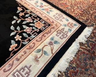 This lot features a large hand-knotted Chinese wool rug with a black and beige floral medallion design. This rug measures, 148” H x 108” W.

