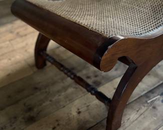 This lot features a British Colonial style plantation lounge chair with a matching ottoman in very good overall condition. The chair measures, 41” H x 24.5” W x 33” W.

