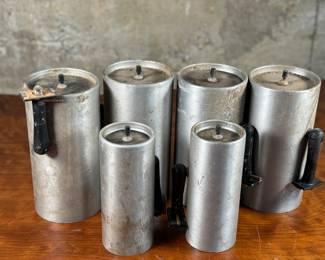 This lot features a set of six (6) cylindrical pendant lights, manufactured by Lightolier. The four larger lights measures, 8.5” H x 4” W x 4” D and the two smaller measure, 7” H x 3” W x 3” D. These lights could use some minor restoration prior to use. A beautiful set of authentic mid-century modern lighting. Lightolier was founded in 1904 by Bernhard Blitzer. Its original name was the New York Gas and Appliance Co., but it was changed to Lightolier, a combination of “light” and “chandelier, ” when electric lighting became more widely accepted.

