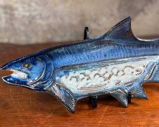 This lot features a fish tray by Blue Spruce Pottery. Signed on the verso and measures, 2” H x 15.5” W x 7” D. Minor repair done to a fin as shown.

