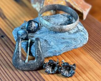 This lot features a curated collection of antique sterling silver items including a bracelet, Taxco earrings, Siam cufflinks, & a belt buckle. Total approx. weight of 63.44 grams.

