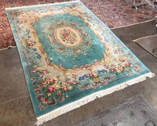 This lot features a hand-knotted Chinese Aubusson wool rug featuring a floral medallion design that measures, 144” H x 107” W.

