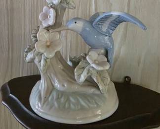 Ceramic hummingbird figurine and carved wall shelf