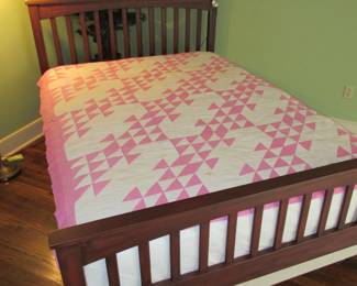 Queen bed with vintage quilt