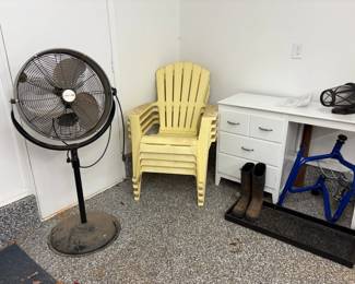 stacking chairs, large fan, small white desk, boots,