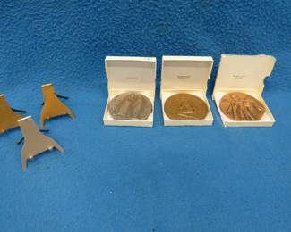 Lot 183. Three "Society of Medalists" bronze medallions. Series #44, #89, and #90. Includes 3 holders. One box is in poor condition.