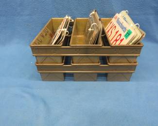 Lot 368. Two vintage bread baking pans with ten sets of matching license plates