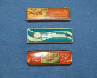Lot 273. Three empty harmonica boxes or tins: Fr. Hotz American Ace tin. Fr. Hotz The Canadian Ace box. Hero harmonica box.