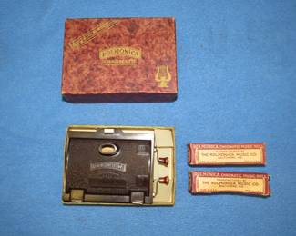 Lot 275. Chromatic Rollmonica player-piano-style harmonica in the box with with three rolls. Works. Minimum bid $50.