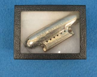 Lot 277. C. A. Seydel Sohne Co. Graf Zeppelin harmonica. Minimum bid $100.