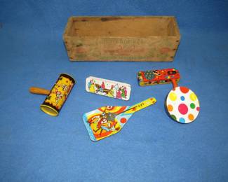 Lot 315. Five tin noise-makers including a Kirchhof in a wooden cheese box