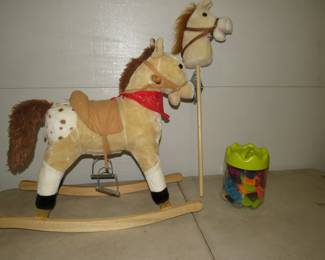 Lot 101. Qaba plush rocking horse in like-new condition. Talks and has sound effects. Stick horse riding stick with sound effects. Bristle Block Stackadoos