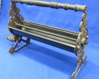 Lot 166. Vintage cast iron newspaper log roller